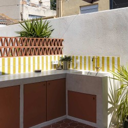 Alternance de carreaux Bejmat Blanc et jaune pour cette crédence de cuisine extérieure